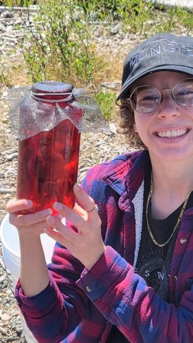 Sierra Joy Williams C’22 holding newly collected O. rubescens